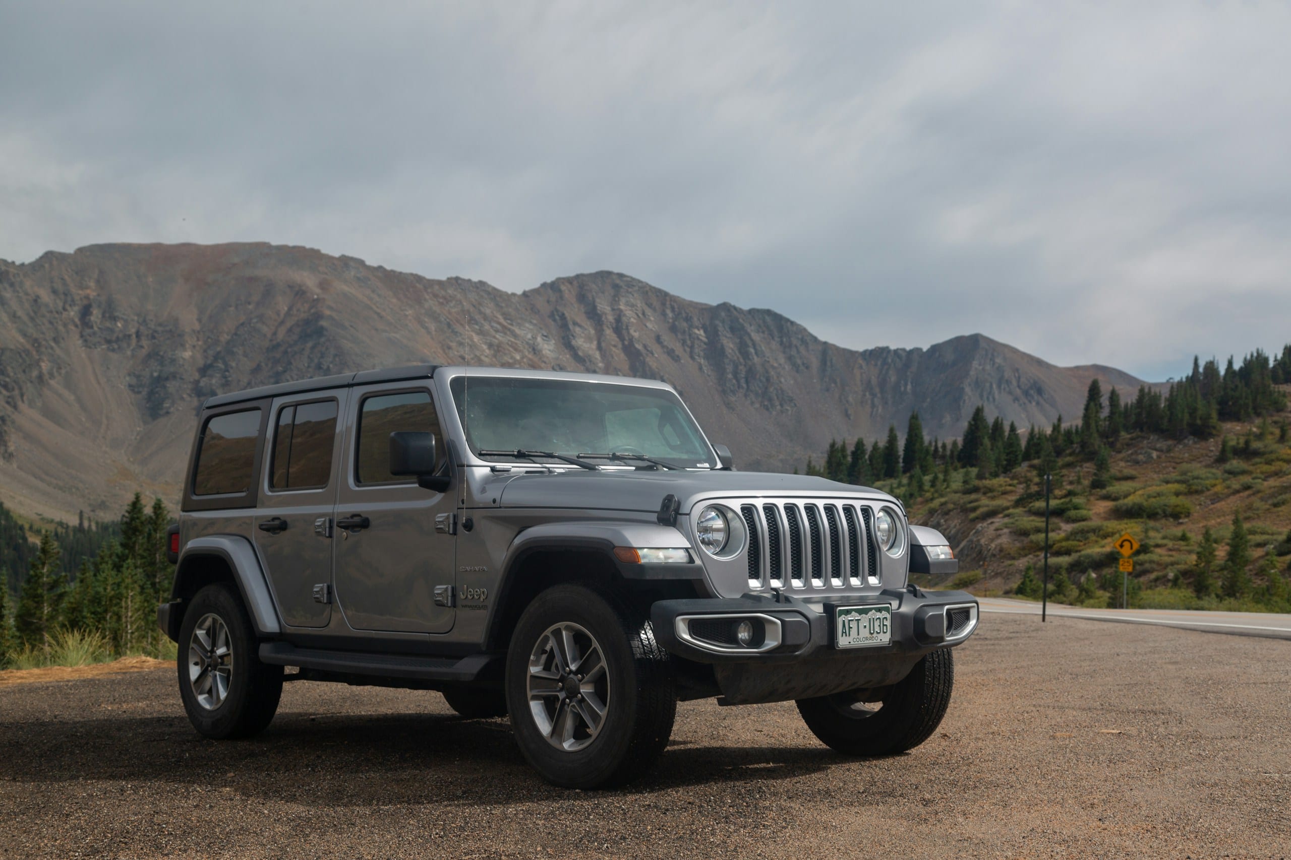 Gray Jeep Wrangler with mountains: Jeep Windshield Replacement, Blue Chip Auto Glass