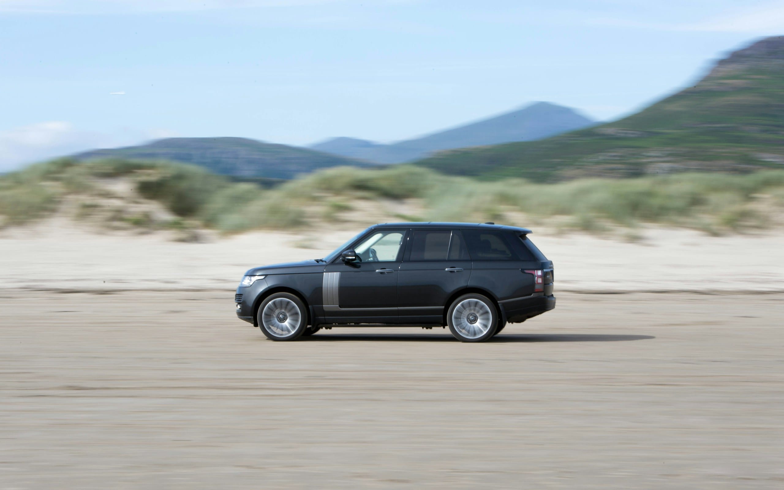Range Rover driving on the sand: Land Rover Auto Glass, Blue Chip Auto Glass