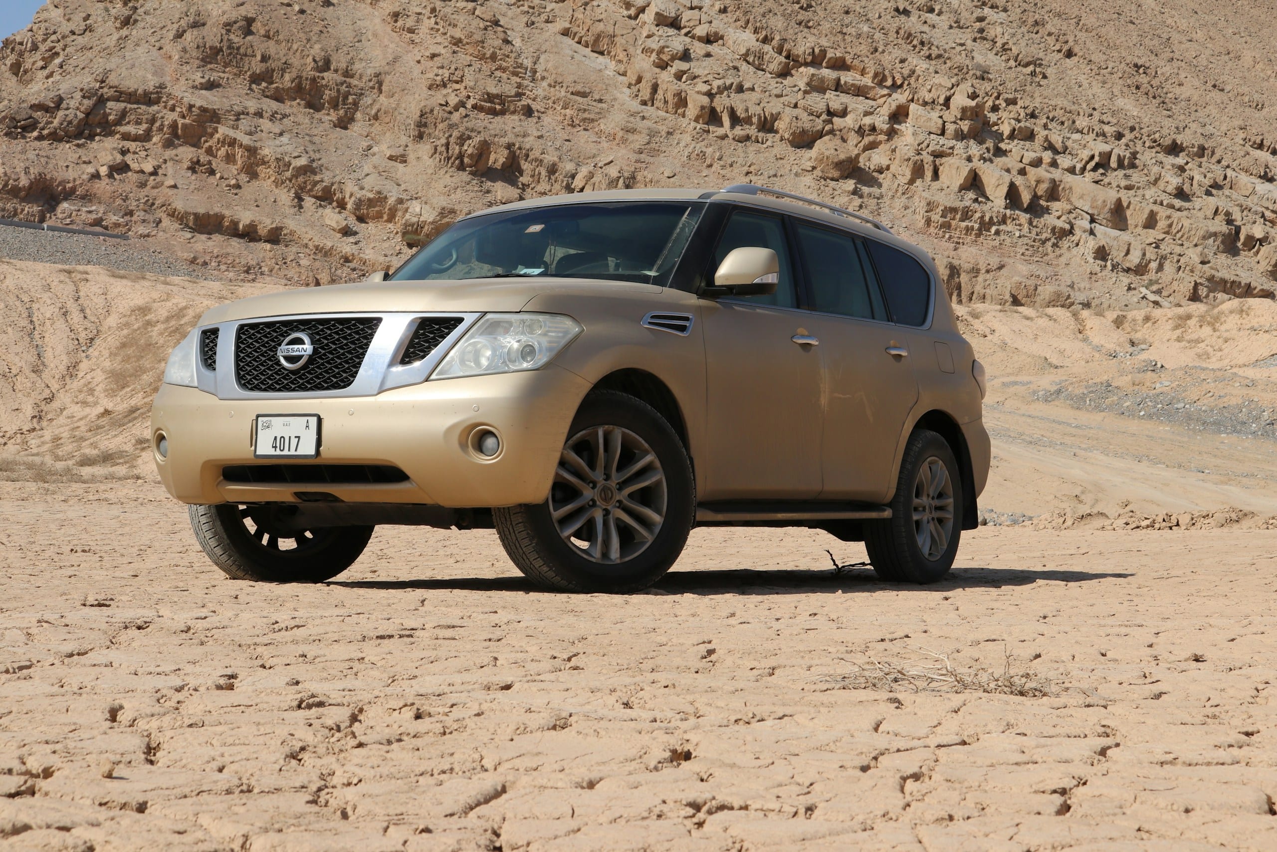 Gold Nissan Armada in the desert: Nissan Windshield Replacement, Blue Chip Auto Glass