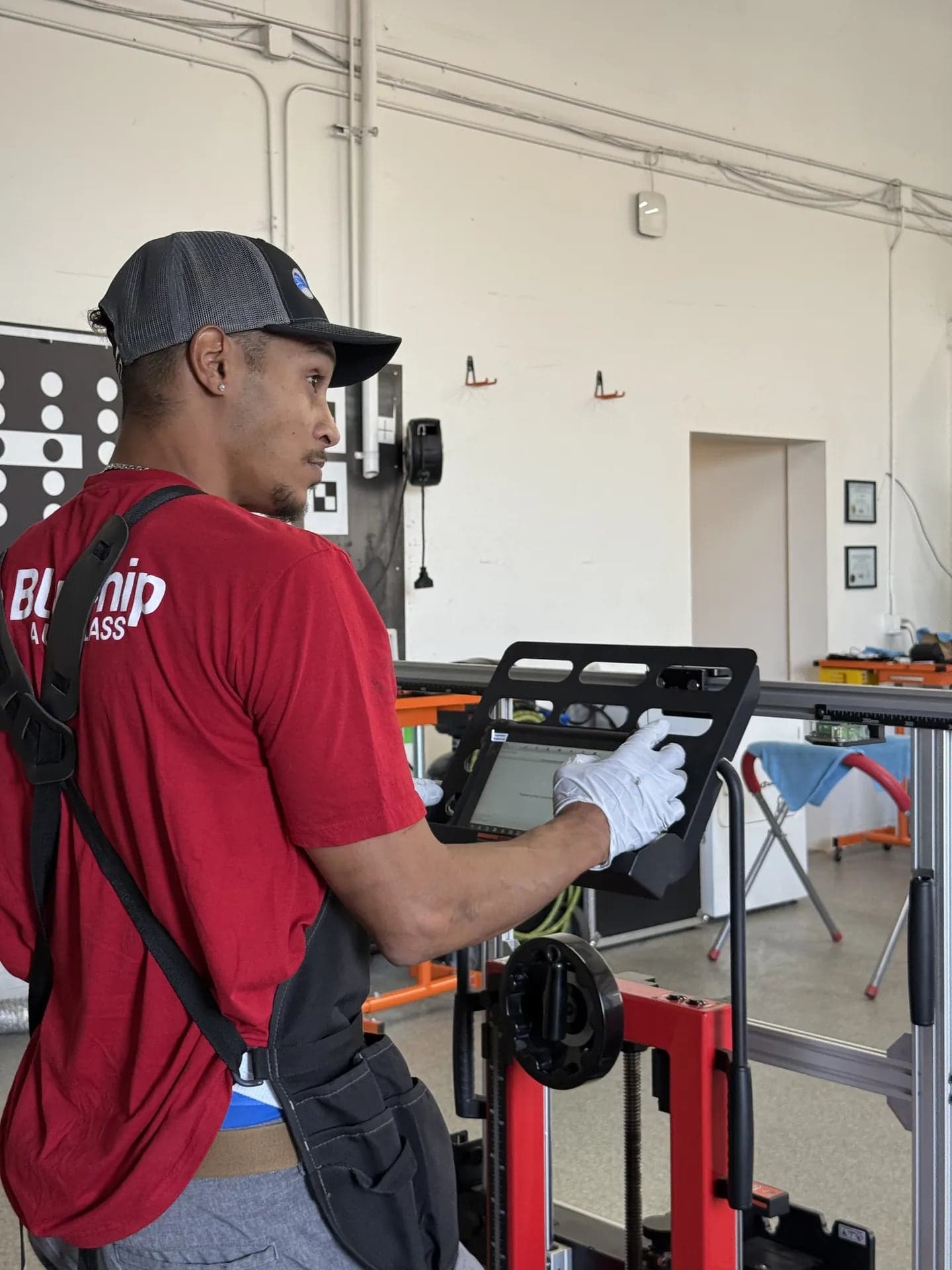 Blue Chip technician running a scan on the Autel diagnostic tablet