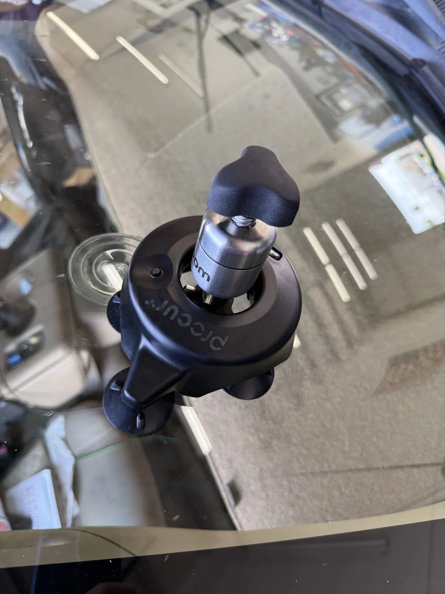 Repair bridge and resin injector mounted over a windshield chip