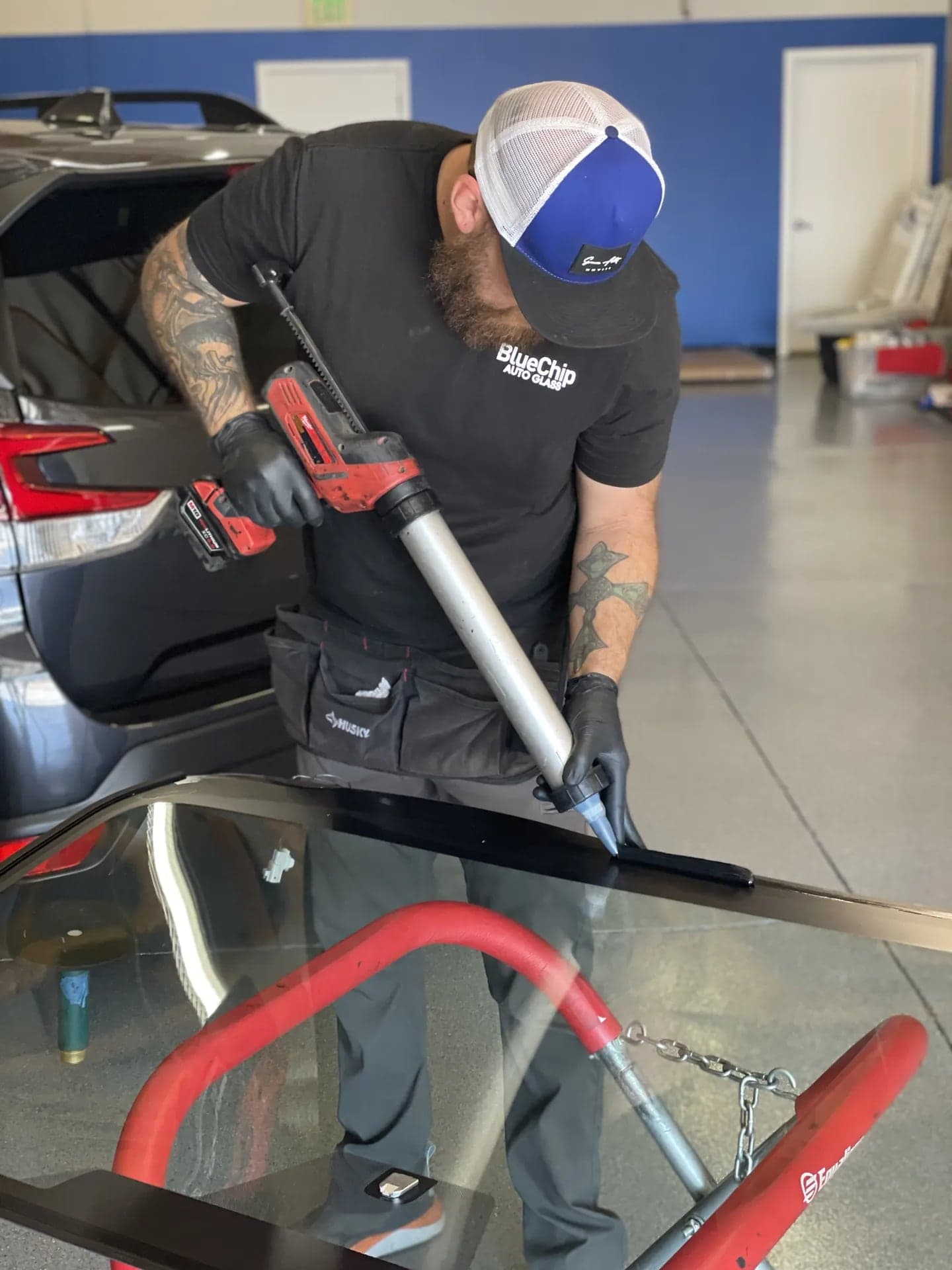 Blue Chip technician applying a bead of urethane adhesive