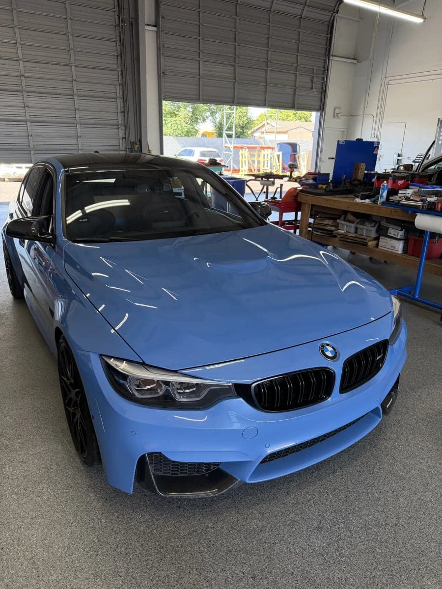 Blue BMW M4 in the Blue Chip Auto Glass shop