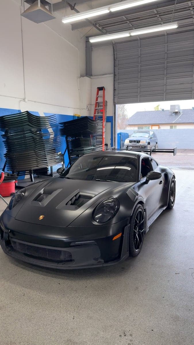 Black Porsche 911 in the Blue Chip Auto Glass shop