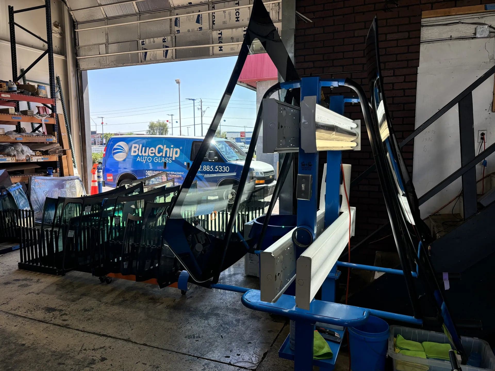 Blue Chip glass inspection stand with windshields waiting to be cleaned and inspected
