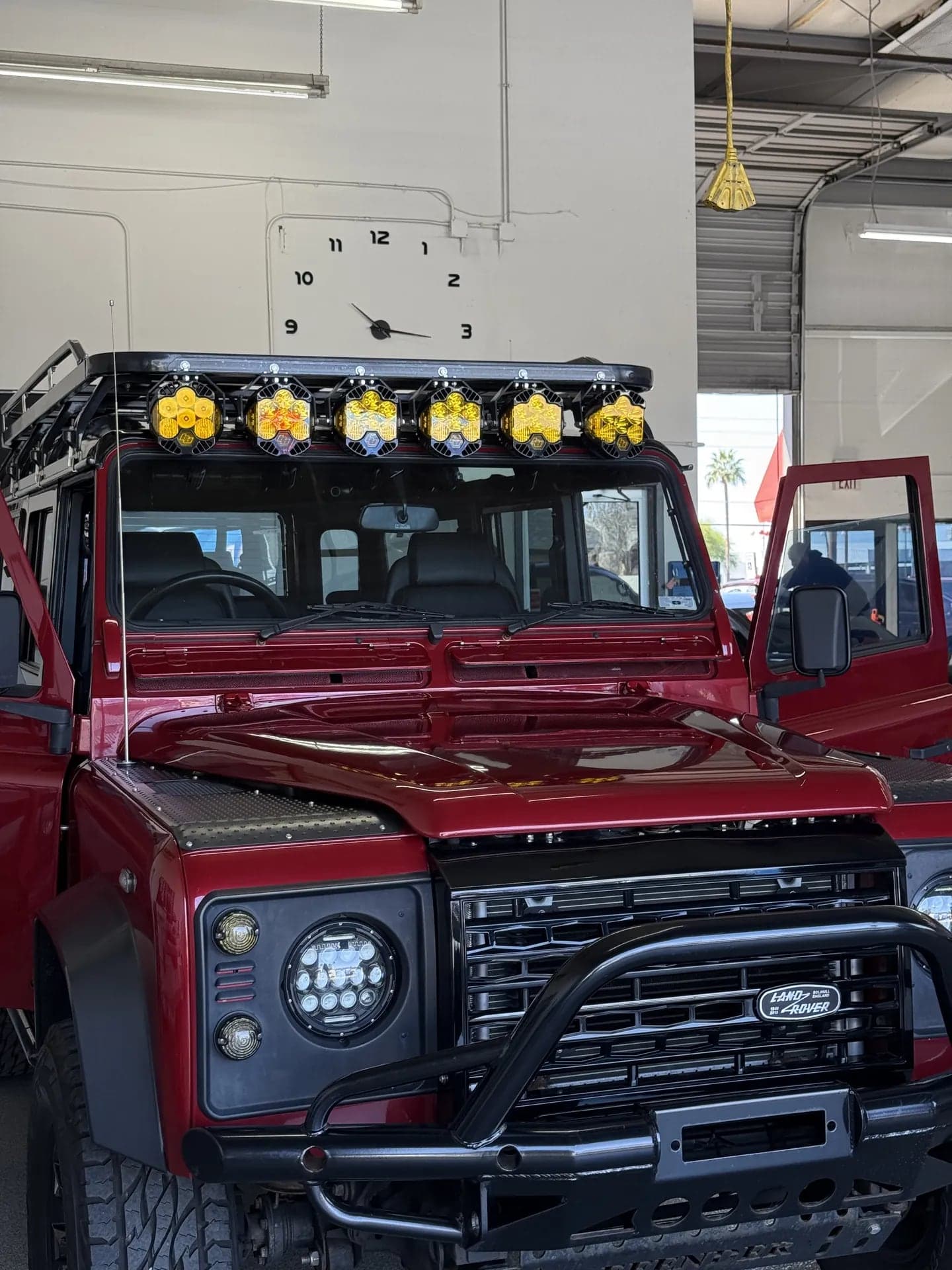 Red Land Rover Defender in the Blue Chip shop