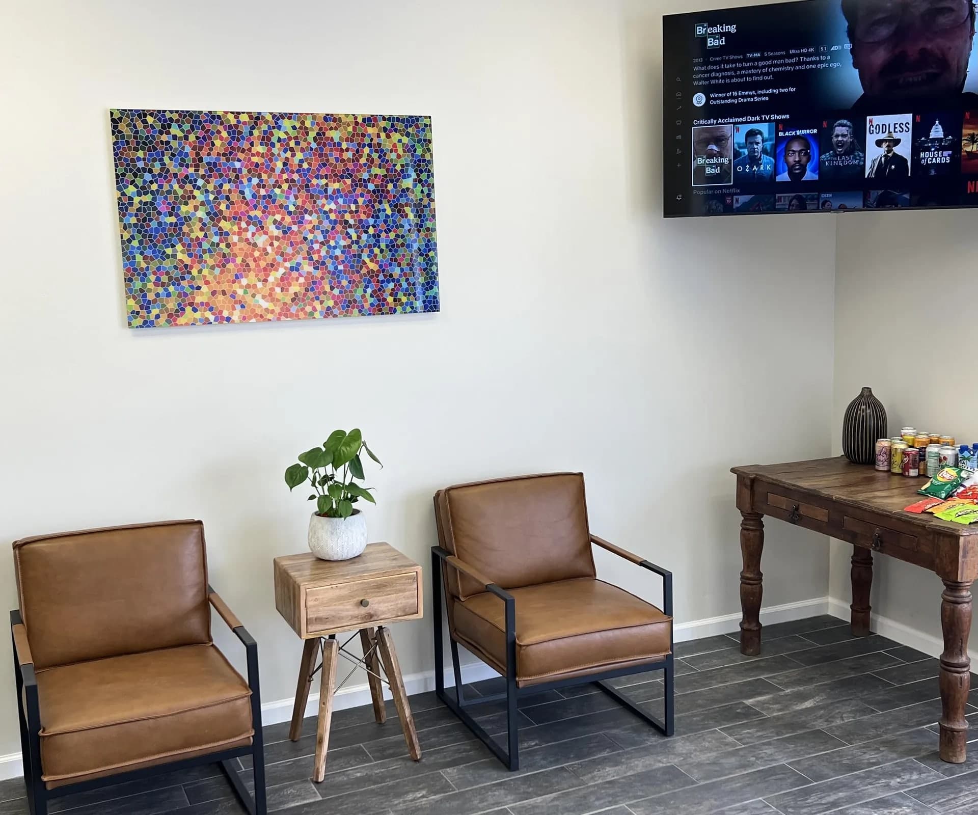 Mesa shop lounge with leather chairs, a plant and colorful artwork
