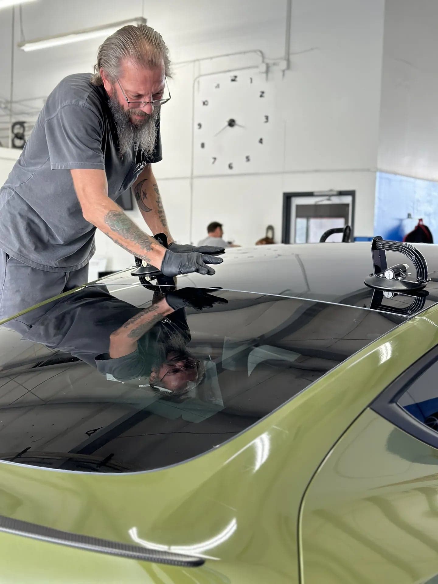 Blue Chip technician setting a new glass roof with suction cups
