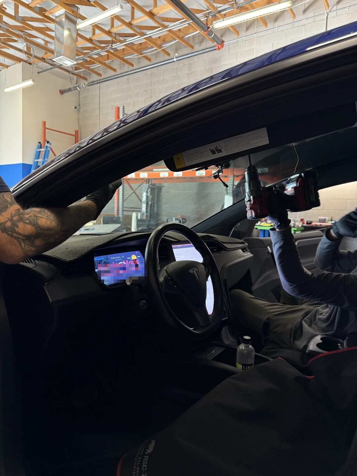 Tesla Model X touchscreen in Service Mode during a windshield install at Blue Chip Auto Glass