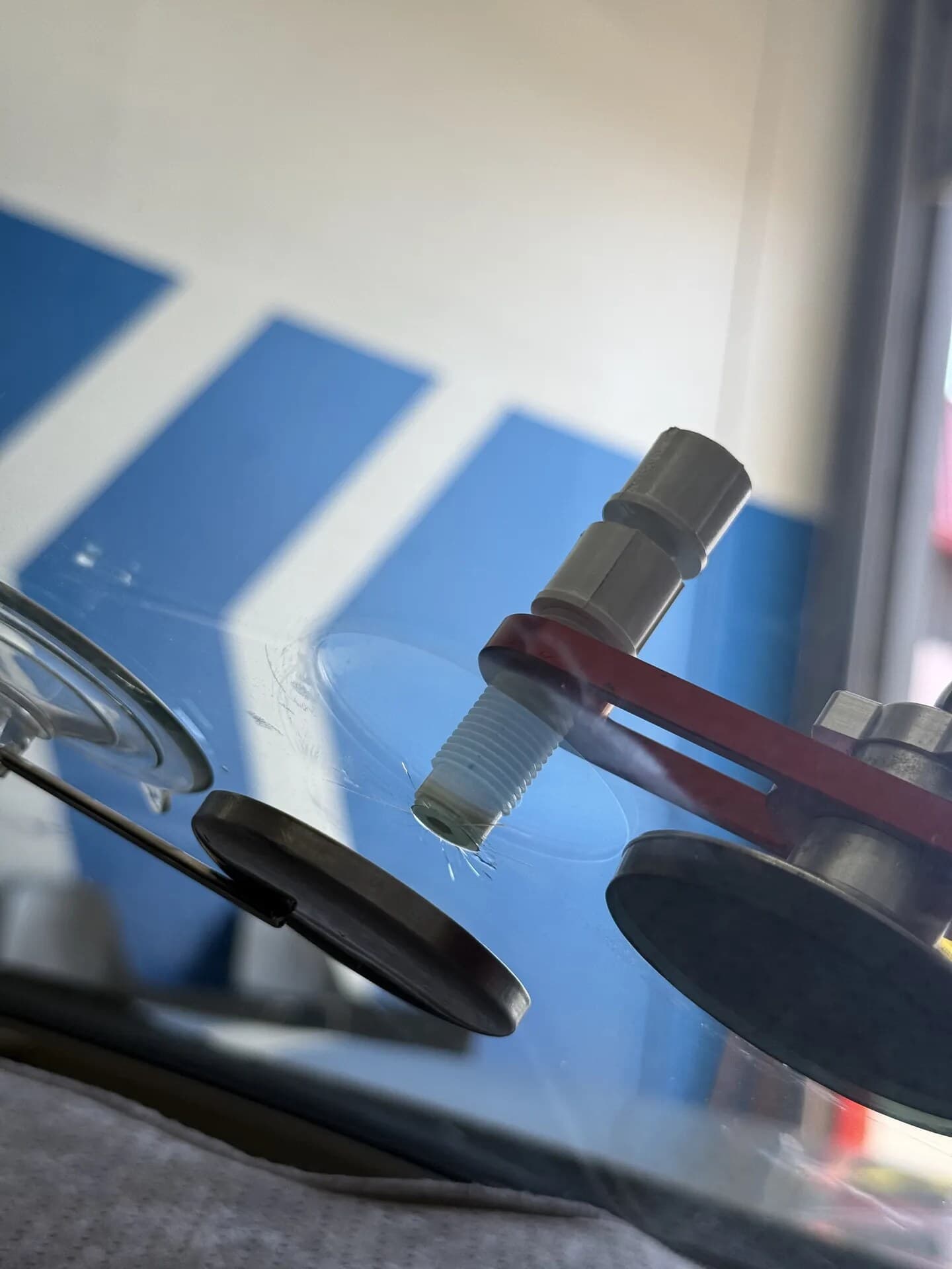 Close-up of resin being injected into a windshield chip