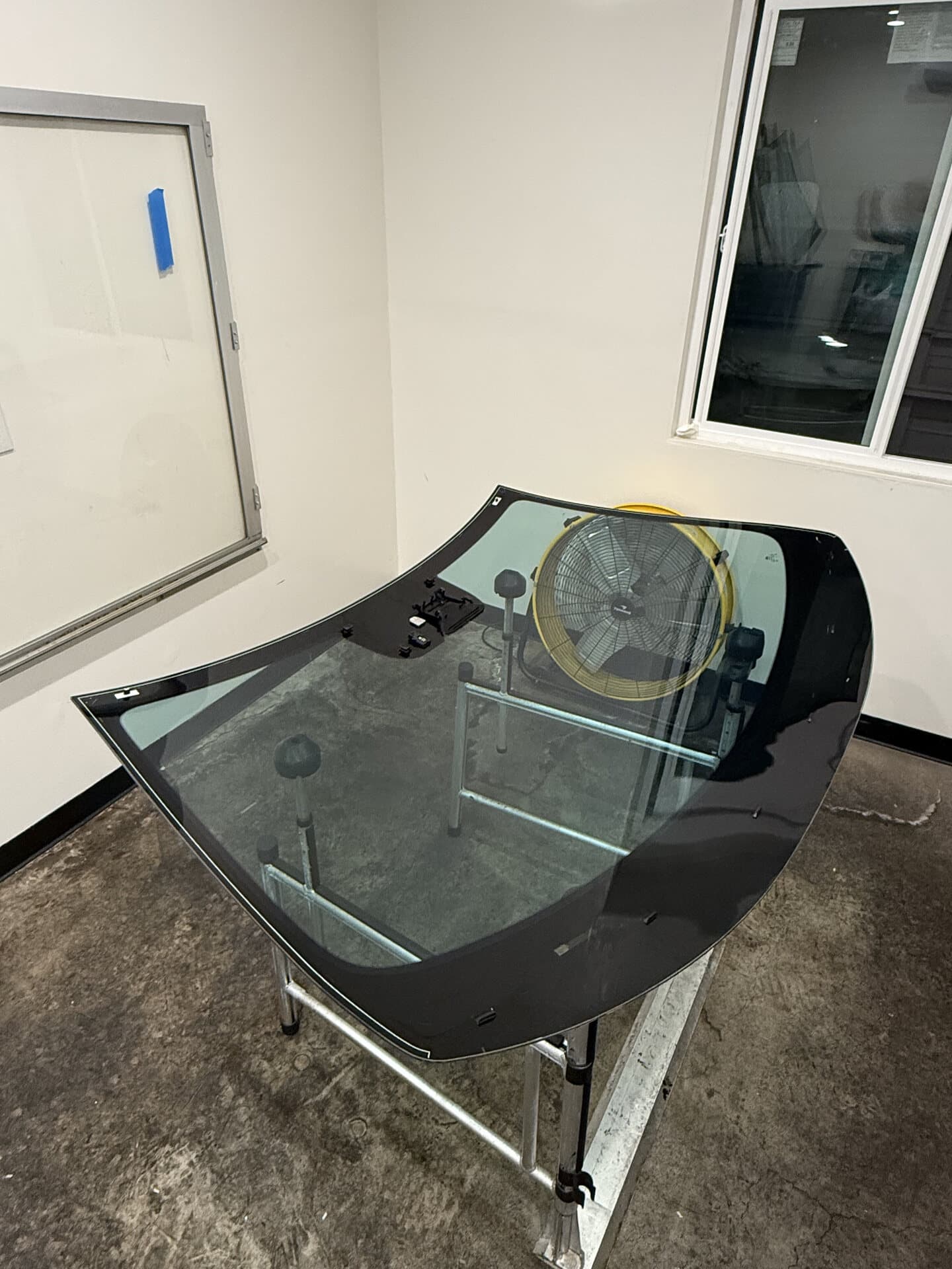 Windshield on a tint stand in the Blue Chip Auto Glass tint room